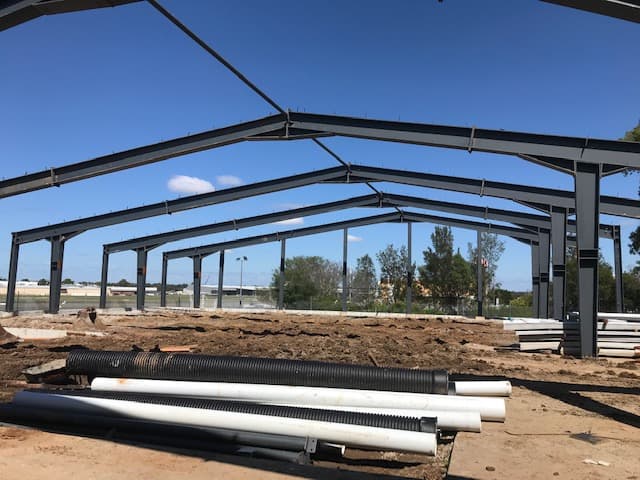 Structural steel portal frames erected at a building site